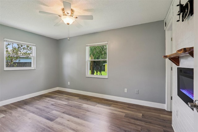 2704 Yule Tree Dr, Edgewater, FL 32141 - unfurnished room with healthy amount of natural light, wood finished floors, ceiling fan, baseboards, and a textured ceiling