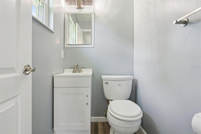 2704 Yule Tree Dr, Edgewater, FL 32141 - half bath with vanity, toilet, and wood finished floors