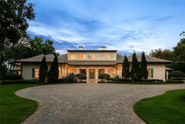 1112 Preserve Point Dr, Winter Park, FL 32789 - view of front of home with curved driveway, stucco siding, a porch, and a front yard