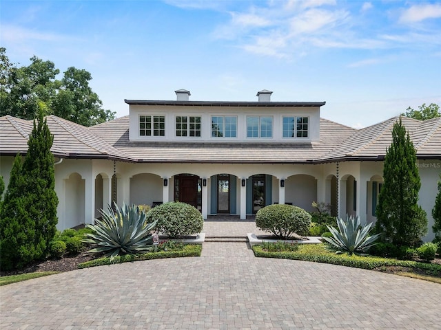 1112 Preserve Point Dr, Winter Park, FL 32789 - view of front of property with stucco siding, covered porch, and a tile roof