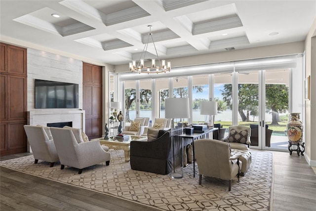 1112 Preserve Point Dr, Winter Park, FL 32789 - living room featuring coffered ceiling, light wood-style floors, beam ceiling, a fireplace, and a chandelier