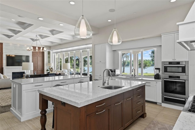 1112 Preserve Point Dr, Winter Park, FL 32789 - kitchen with a center island with sink, a sink, recessed lighting, open floor plan, and coffered ceiling