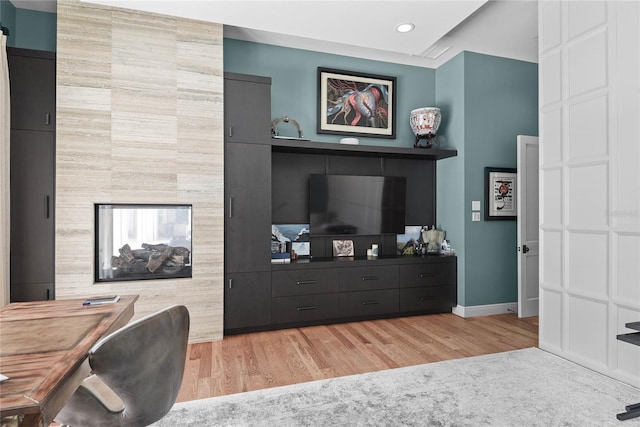 1112 Preserve Point Dr, Winter Park, FL 32789 - office area featuring light wood-type flooring, recessed lighting, baseboards, an accent wall, and a tiled fireplace