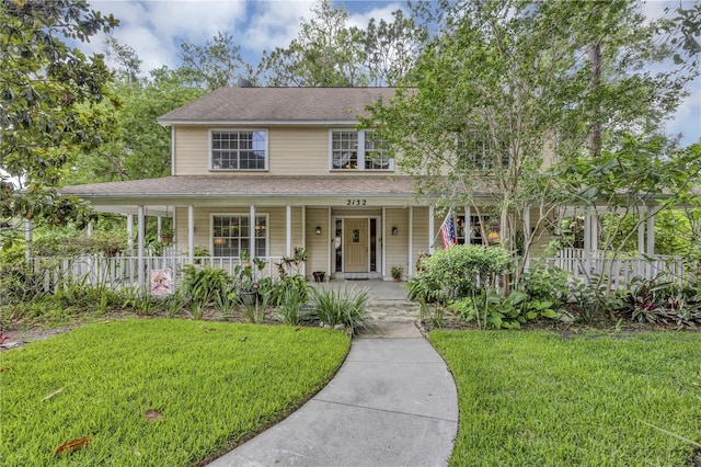 2132 Palm Vista Dr, Apopka, FL 32712 - view of front of property with a porch, a front yard, and a shingled roof