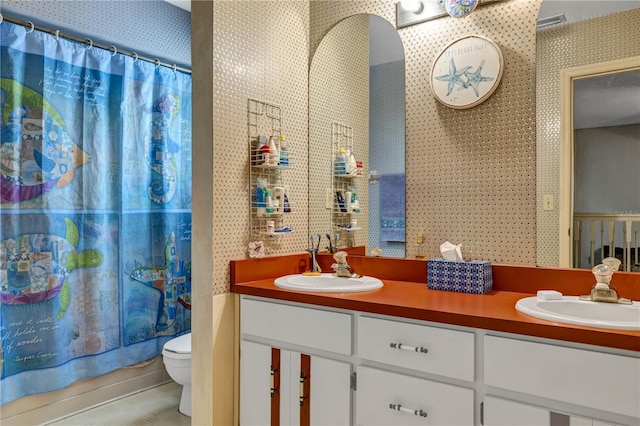 2132 Palm Vista Dr, Apopka, FL 32712 - bathroom featuring wallpapered walls, double vanity, and toilet