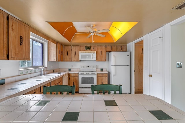 885 Little Bend Rd, Altamonte Springs, FL 32714 - kitchen featuring white appliances, tile countertops, a sink, ceiling fan, and brown cabinetry