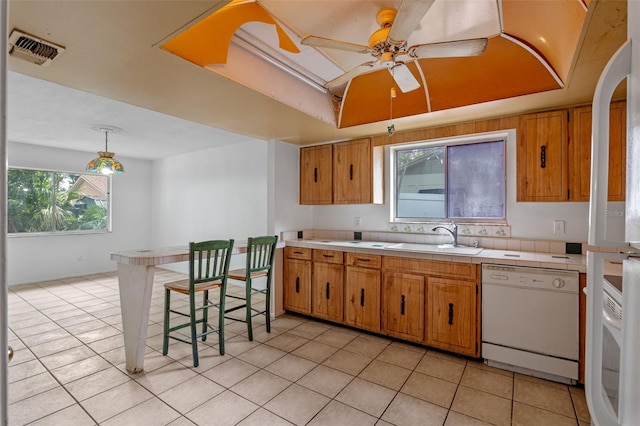 885 Little Bend Rd, Altamonte Springs, FL 32714 - kitchen featuring white dishwasher, a sink, brown cabinets, and light tile patterned floors