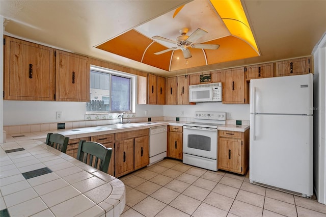 885 Little Bend Rd, Altamonte Springs, FL 32714 - kitchen featuring white appliances, tile countertops, a sink, light tile patterned flooring, and ceiling fan