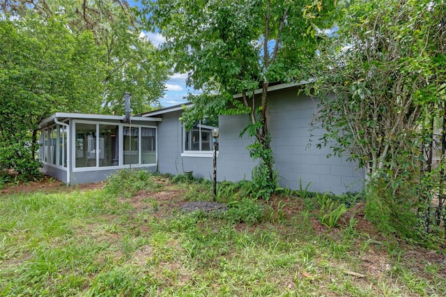 885 Little Bend Rd, Altamonte Springs, FL 32714 - rear view of property with a sunroom and concrete block siding
