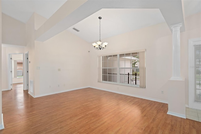 11648 Grand Bay Blvd, Clermont, FL 34711 - empty room with ornate columns, light wood-style flooring, a chandelier, baseboards, and lofted ceiling