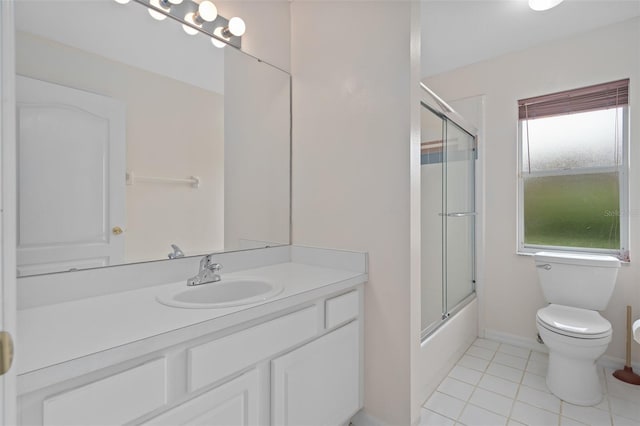 11648 Grand Bay Blvd, Clermont, FL 34711 - full bathroom featuring vanity, toilet, tile patterned flooring, bath / shower combo with glass door, and baseboards