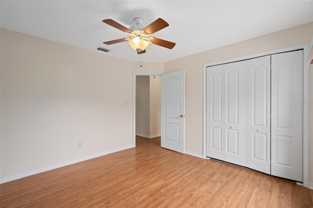 11648 Grand Bay Blvd, Clermont, FL 34711 - unfurnished bedroom featuring light wood-style floors, baseboards, a closet, and ceiling fan