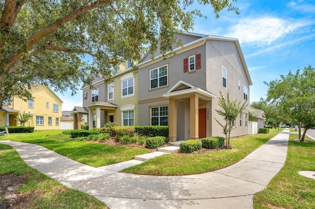 12963 Garridan Ave, Windermere, FL 34786 - view of property with a front lawn, stucco siding, and a residential view