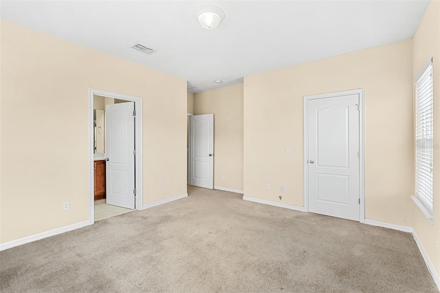 12963 Garridan Ave, Windermere, FL 34786 - unfurnished bedroom featuring light colored carpet, baseboards, and ensuite bath