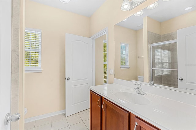 12963 Garridan Ave, Windermere, FL 34786 - bathroom featuring toilet, tile patterned floors, vanity, a shower stall, and baseboards