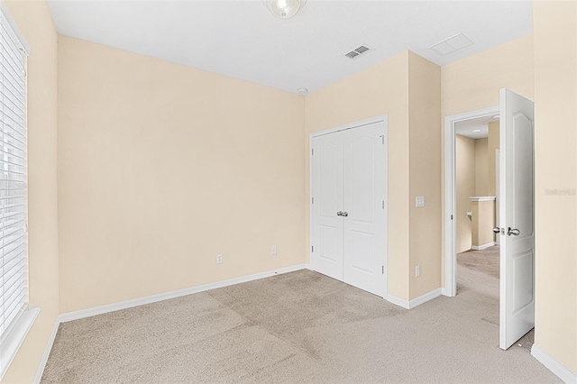 12963 Garridan Ave, Windermere, FL 34786 - unfurnished bedroom featuring light carpet, baseboards, multiple windows, and a closet