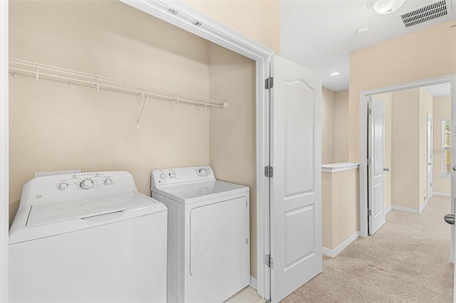 12963 Garridan Ave, Windermere, FL 34786 - washroom featuring washing machine and clothes dryer, light carpet, and baseboards