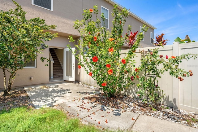 12963 Garridan Ave, Windermere, FL 34786 - view of exterior entry featuring a patio area and stucco siding