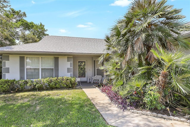 5382 SW 84th Pl, Ocala, FL 34476 - view of front facade with stucco siding, a front lawn, and roof with shingles