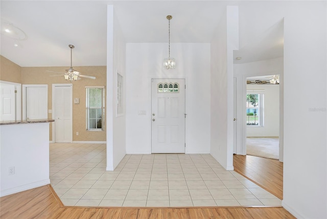 5382 SW 84th Pl, Ocala, FL 34476 - foyer entrance with light tile patterned flooring, ceiling fan, lofted ceiling, baseboards, and a chandelier