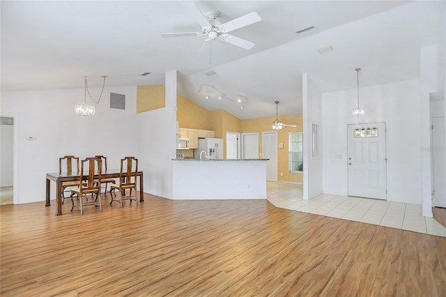 5382 SW 84th Pl, Ocala, FL 34476 - living area featuring a ceiling fan, light wood finished floors, high vaulted ceiling, and a chandelier
