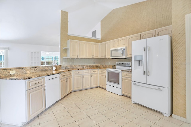 5382 SW 84th Pl, Ocala, FL 34476 - kitchen featuring white appliances, a sink, light stone countertops, light tile patterned floors, and a peninsula