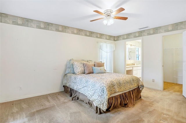 5382 SW 84th Pl, Ocala, FL 34476 - bedroom featuring light colored carpet, baseboards, a spacious closet, and ensuite bathroom
