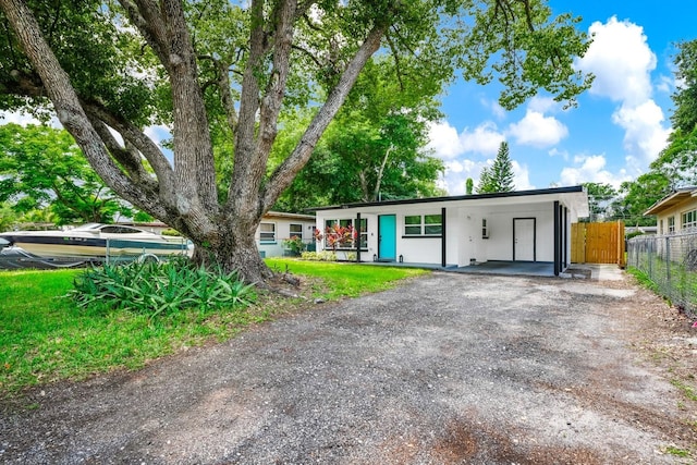7616 Simms Ave, Orlando, FL 32812 - ranch-style home featuring a carport and driveway