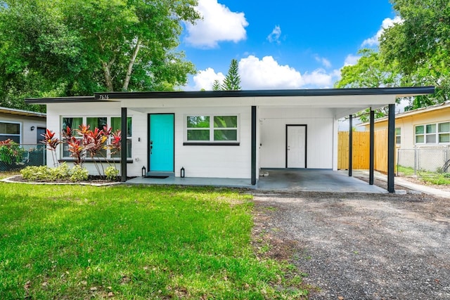 7616 Simms Ave, Orlando, FL 32812 - view of front facade featuring an attached carport and driveway