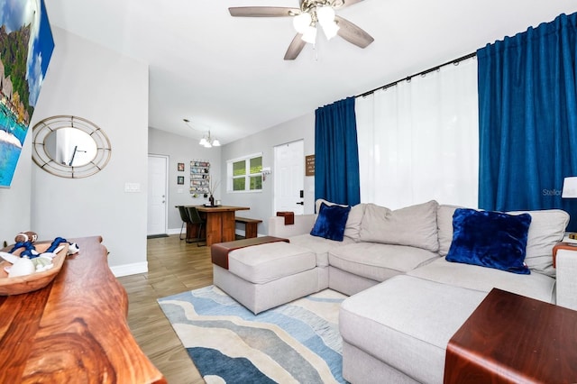 7616 Simms Ave, Orlando, FL 32812 - living room with light wood-type flooring, vaulted ceiling, ceiling fan, and baseboards