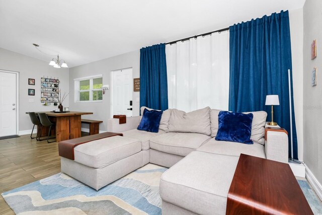 7616 Simms Ave, Orlando, FL 32812 - living room with a chandelier, wood finished floors, and baseboards