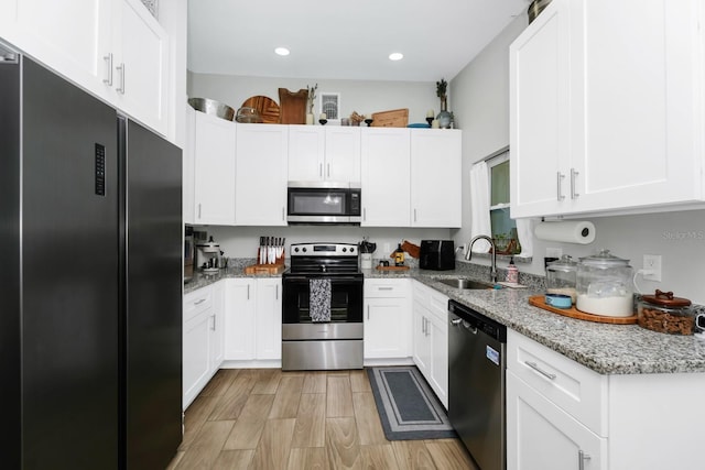 7616 Simms Ave, Orlando, FL 32812 - kitchen featuring appliances with stainless steel finishes, a sink, white cabinetry, and recessed lighting