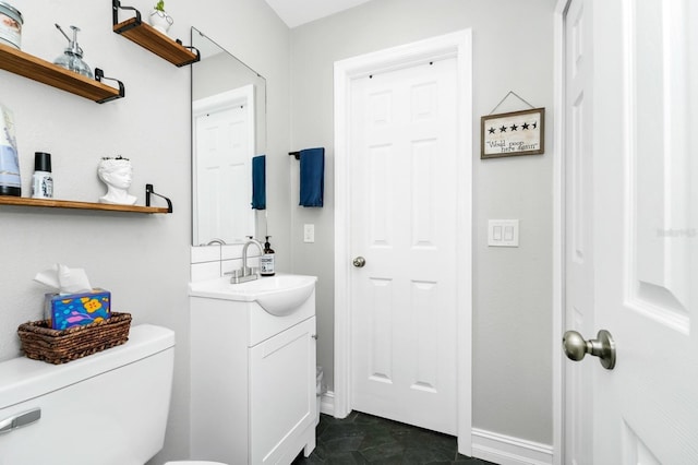 7616 Simms Ave, Orlando, FL 32812 - bathroom featuring vanity, toilet, and baseboards