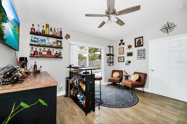 7616 Simms Ave, Orlando, FL 32812 - bar area with light wood-style flooring, ceiling fan, and baseboards