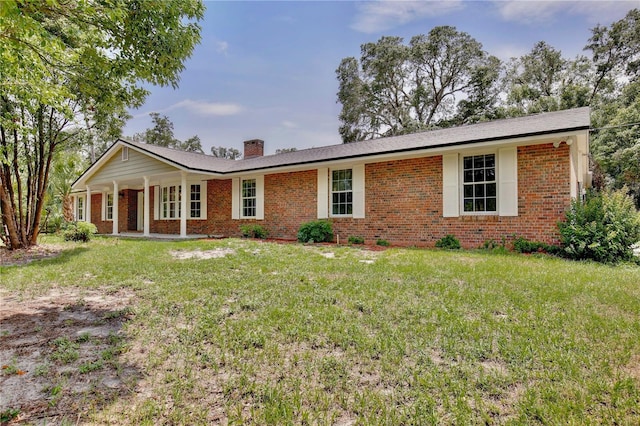 4802 Anton Ave, Apopka, FL 32712 - ranch-style house featuring brick siding, a chimney, a front lawn, and covered porch