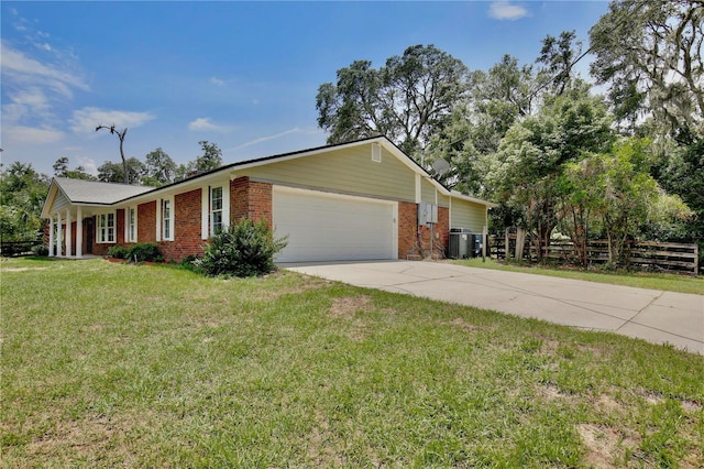 4802 Anton Ave, Apopka, FL 32712 - view of front of property with brick siding, an attached garage, driveway, and central AC unit