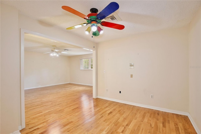 4802 Anton Ave, Apopka, FL 32712 - unfurnished room featuring ceiling fan, light wood-style floors, baseboards, and a textured ceiling