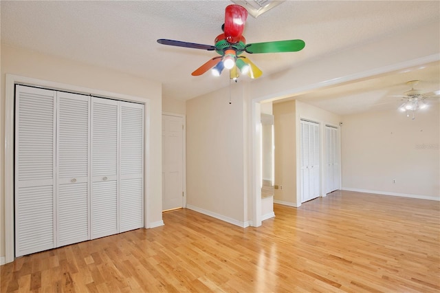 4802 Anton Ave, Apopka, FL 32712 - unfurnished bedroom with light wood finished floors, baseboards, and a ceiling fan