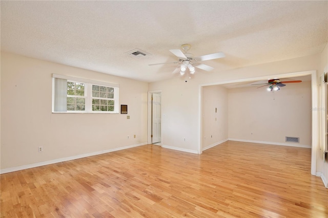 4802 Anton Ave, Apopka, FL 32712 - empty room with ceiling fan, light wood-style flooring, a textured ceiling, and baseboards