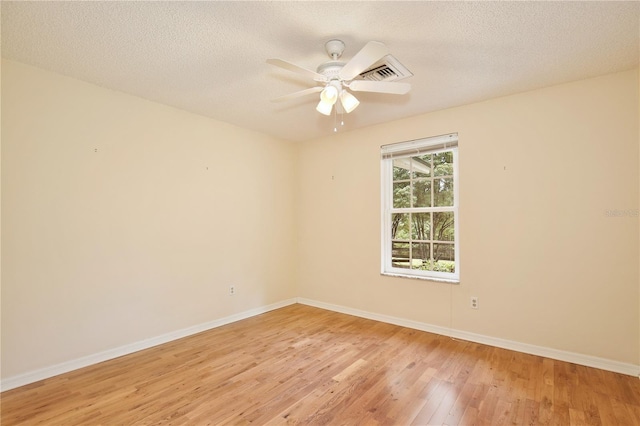 4802 Anton Ave, Apopka, FL 32712 - spare room with light wood finished floors, baseboards, a ceiling fan, and a textured ceiling