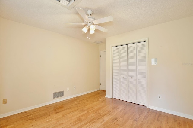 4802 Anton Ave, Apopka, FL 32712 - unfurnished bedroom featuring light wood-type flooring, a closet, baseboards, ceiling fan, and a textured ceiling