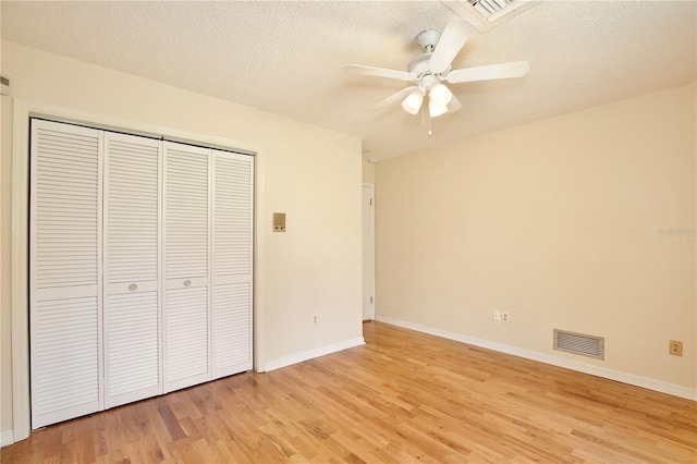 4802 Anton Ave, Apopka, FL 32712 - unfurnished bedroom with light wood finished floors, a closet, baseboards, a textured ceiling, and ceiling fan