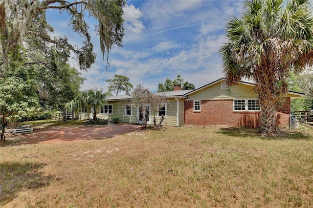 4802 Anton Ave, Apopka, FL 32712 - rear view of house featuring brick siding and a chimney