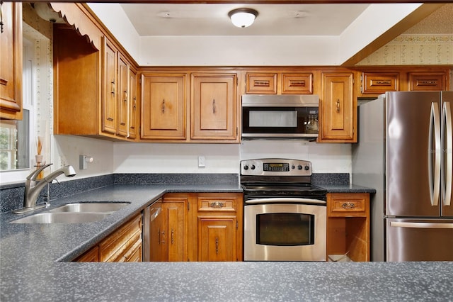 4802 Anton Ave, Apopka, FL 32712 - kitchen with appliances with stainless steel finishes, dark countertops, and brown cabinetry
