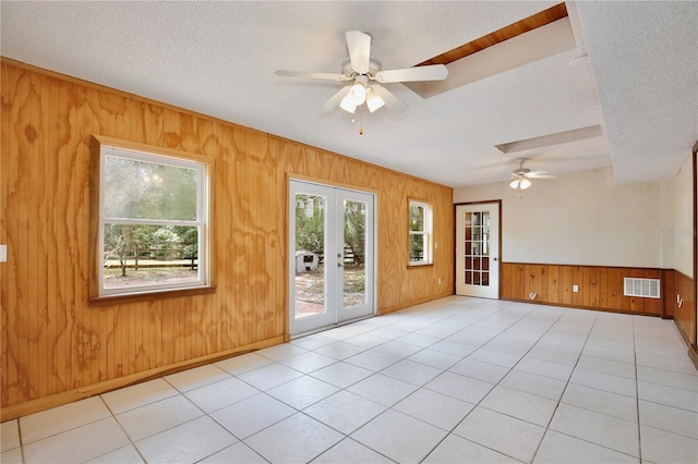 4802 Anton Ave, Apopka, FL 32712 - unfurnished room featuring ceiling fan, wooden walls, a textured ceiling, french doors, and light tile patterned floors