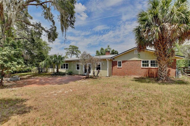 4802 Anton Ave, Apopka, FL 32712 - back of house featuring brick siding and a chimney