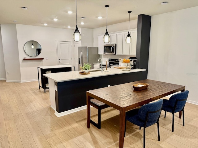 1900 Erudite Way, Winter Park, FL 32792 - kitchen with stainless steel appliances, light wood-type flooring, a sink, light countertops, and recessed lighting