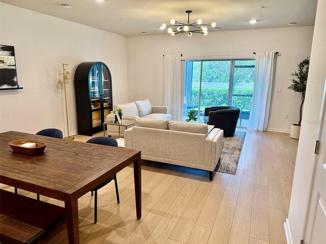 1900 Erudite Way, Winter Park, FL 32792 - living room with light wood-style floors, a chandelier, and baseboards