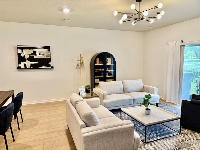 1900 Erudite Way, Winter Park, FL 32792 - living room with light wood-style flooring, a chandelier, and baseboards