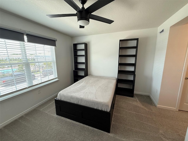 1900 Erudite Way, Winter Park, FL 32792 - carpeted bedroom with baseboards, a textured ceiling, and a ceiling fan